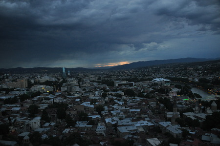 Tbilisi. View of the city and a monument to the mother of Georgia from the hill during the storm.の写真素材