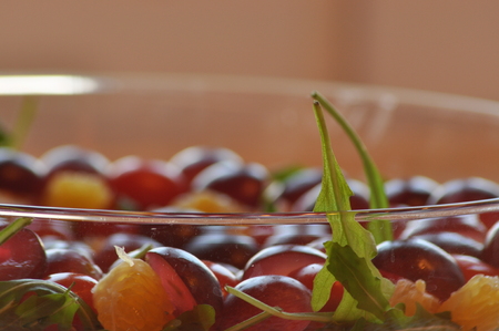 Salad in a glass dish. Rocket salad with grapes.の写真素材