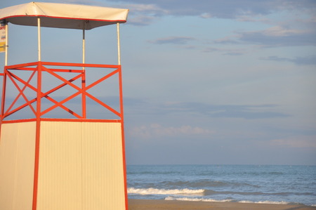 Tower of a marine lifeguard with a red flag hanging out. Swimming prohibited.の写真素材