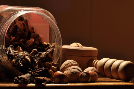 Dried mushrooms spilling from the container. Food ingredients. Forest fruits. Autumn harvest.
