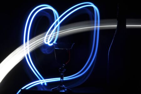 Champagne on New Year's Eve. Fajerwerek flares. New Year's greetings. Happiness and fun.の写真素材