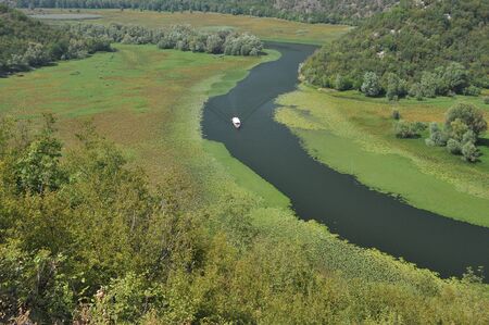 Rijeka Crnojevica, part of the Skadar Lake in Montenegro. Tourist cruises by boat on the beautiful...