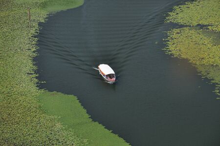 Rijeka Crnojevica, part of the Skadar Lake in Montenegro. Tourist cruises by boat on the beautiful meanders of the river flowing between the hills.の写真素材
