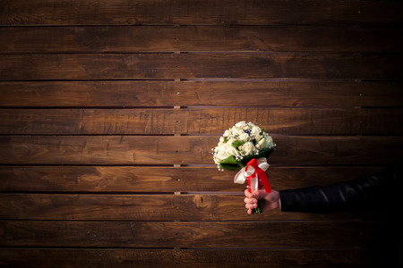 wedding bouquet of white roses in groomの写真素材