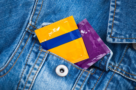 Condom in the pocket of blue jeans jacketの写真素材