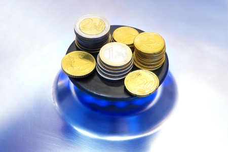 Blue flames of natural gas burning from a gas stove with euro coinsの写真素材