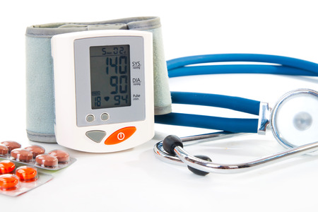 Stethoscope, blood pressure checker and pills, tablets isolated on whiteの写真素材