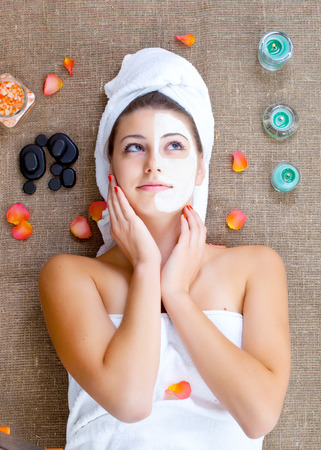 Girl with face mask on a stone therapy, hot stone massageの写真素材