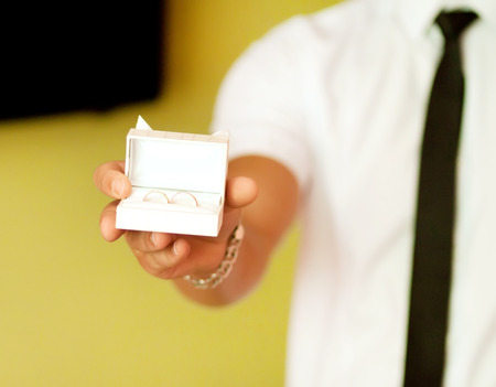 groom with rings box in the morningの写真素材