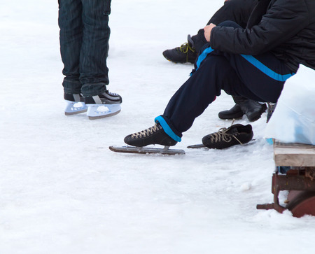 man with ice skates on winter iceの写真素材