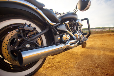 Big, clean, black and unknown chopper bike in desert