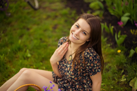 Portrait of young woman in old vintage dress in garden, park in spring, summerの写真素材