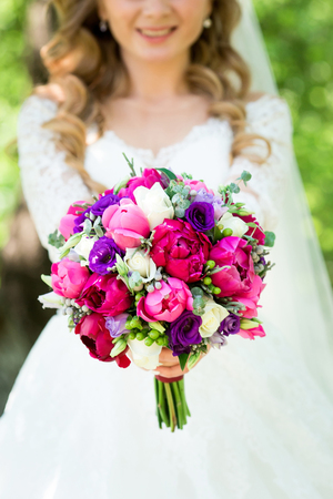Young Happy Bride With Flower Bouquet on swingの写真素材