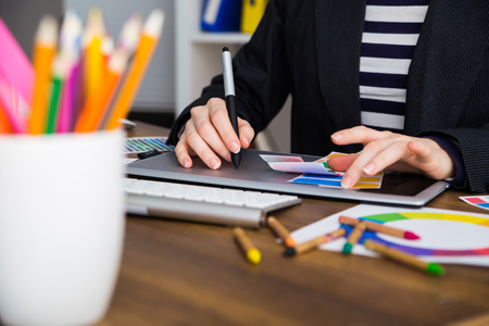 Young Handsome Graphic designer using graphics tablet to do his work at deskの写真素材