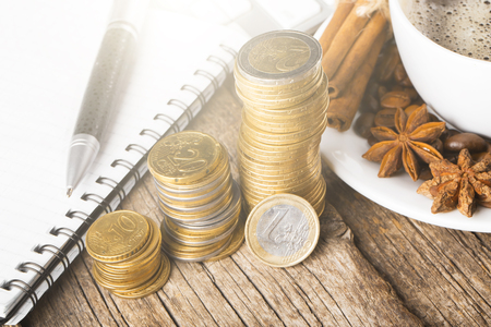 Euro coins with office things on wooden deskの写真素材