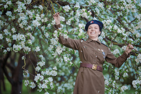 A young female pilot in uniform of Soviet Army pilots during the World War II. Military shirt with...