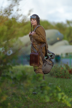A young female pilot in uniform of Soviet Army pilots during the World War II. Military shirt with...