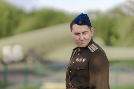 A young adult male pilot in the uniform of pilots of the Soviet Army of the World War II period....