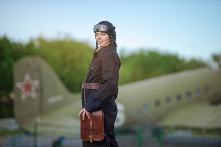 A young female pilot in uniform of Soviet Army pilots during the World War II. Black flying...