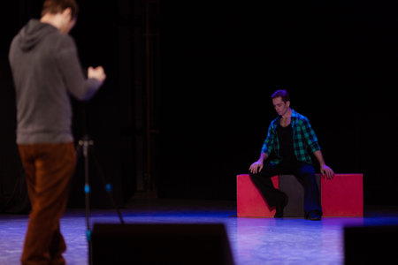 Actor dancer young man performs in the theater on stage in a dance musical show