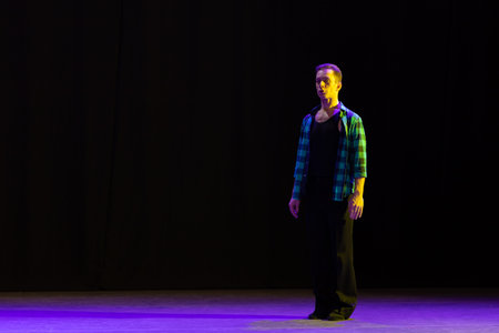 Actor dancer young man performs in the theater on stage in a dance musical show
