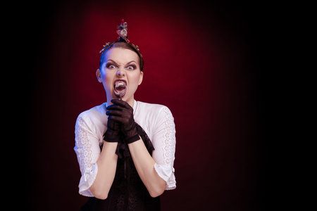 Emotional woman in steampunk costume posing in blue and red stage light