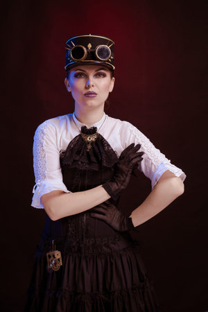 Emotional woman in steampunk costume posing in blue and red stage light