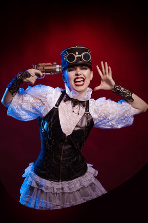 Emotional woman in steampunk costume posing in blue and red stage light