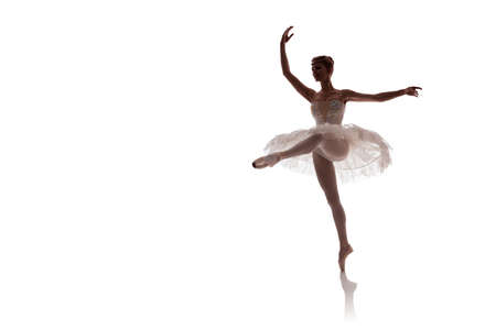 woman ballerina in white pack posing on white background photo made in the style of "low key"の写真素材