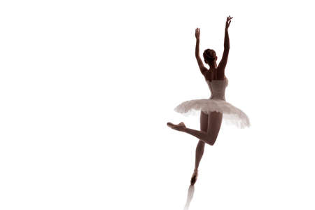 woman ballerina in white pack posing on white background photo made in the style of "low key"の写真素材