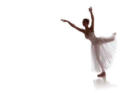 woman ballerina in white long skirt posing on white background photo made in the style of "low key"の写真素材