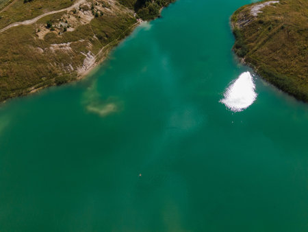 Landscape, sandy seashore and turquoise water, blue sky with white clouds. View from a flying drone....