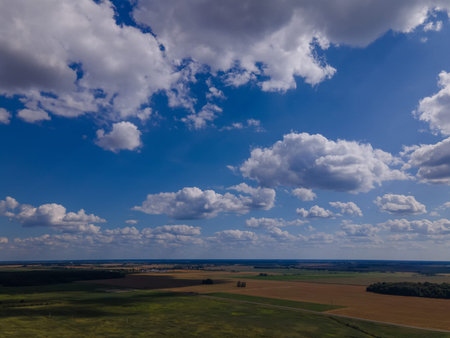 Landscape view from drone, yellow and green fields and haystacks