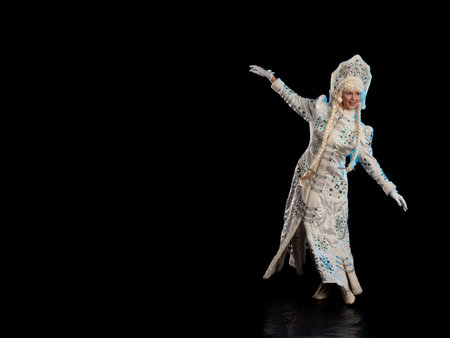 Snow Maiden in a white fur coat, kokoshnik and long hair braids posing on a black background