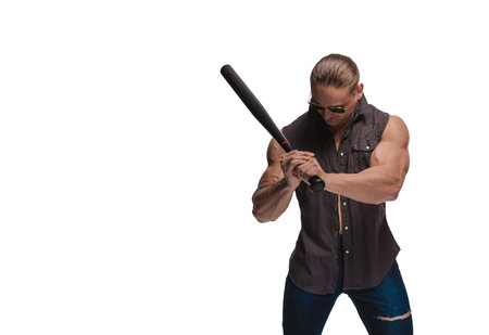 Portrait of a brutal man bodybuilder in sunglasses with a baseball bat on a white background