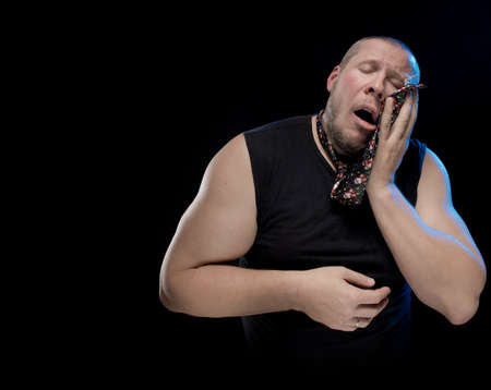 Emotional comic actor gesturing man in a tie on a black background, Christmas and New Yearの写真素材