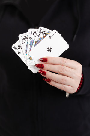 Female hands hold a deck of cards and show tricks. The photographer is the author of the design of...