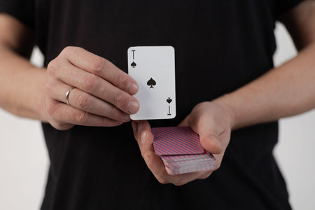 Male hands hold a deck of cards and show tricks. The photographer is the author of the design of...