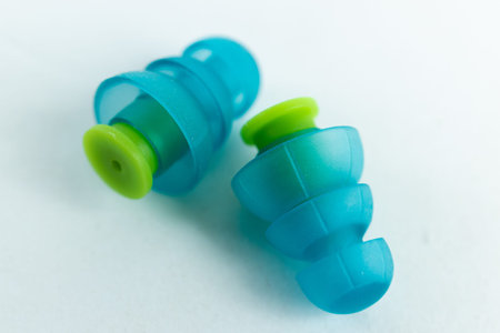 Silicone ear plugs for human ears on white background