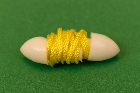 Silicone reusable ear plugs for human ears on green background