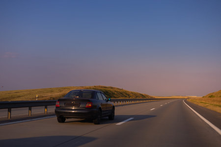 Evening view at sunset. Highway road in the countryside, roadside and asphalt