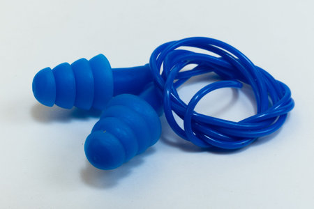 Silicone ear plugs for human ears on white background