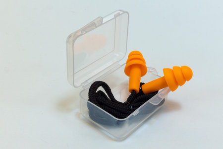 Silicone ear plugs for human ears on white background