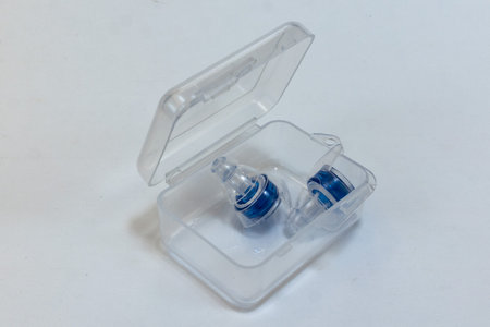 Silicone ear plugs for human ears on white background