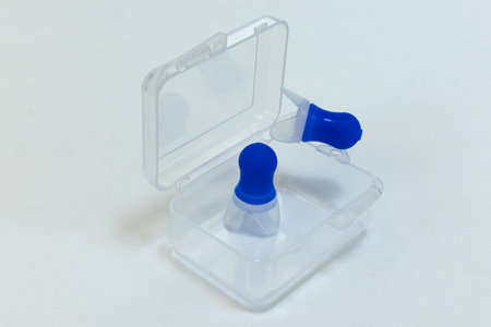 Silicone ear plugs for human ears on white background