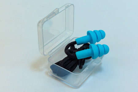 Silicone ear plugs for human ears on white background