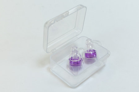 Silicone ear plugs for human ears on white background