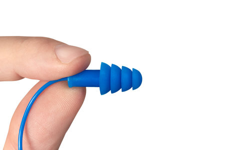 Silicone ear plugs for human ears on white background