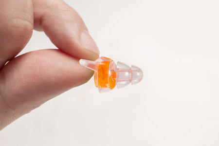 Silicone ear plugs for human ears on white background