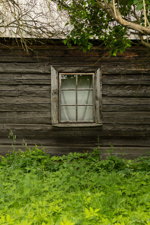 Texture background, window on the wall of a wooden and stone houseの写真素材